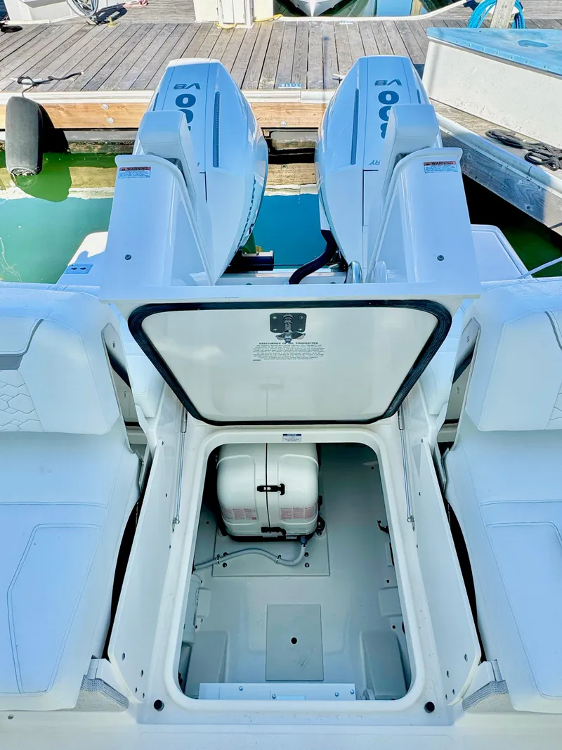Slide: The Image of 2025 Tiara Yachts 34 LX with open engine compartment, docked at marina. - 41