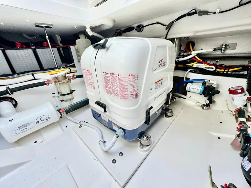 Slide: The Image of Engine compartment of 2025 Tiara Yachts 34 LX, showcasing mechanical components and wiring. - 43