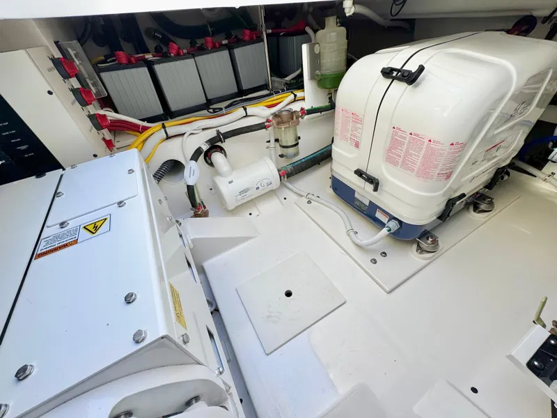 Slide: The Image of Engine compartment of 2025 Tiara Yachts 34 LX, showcasing equipment and wiring. - 44