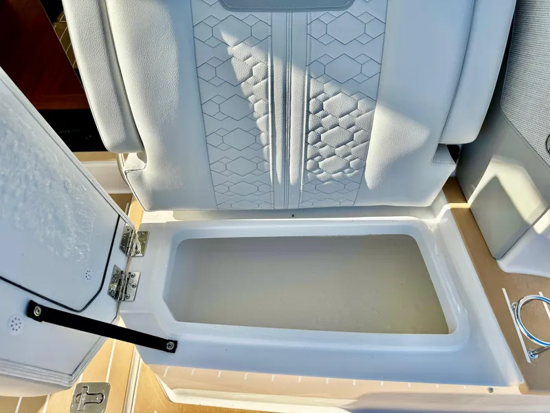 Slide: The Image of Storage compartment on 2025 Tiara Yachts 43 LE with textured interior design. - 16