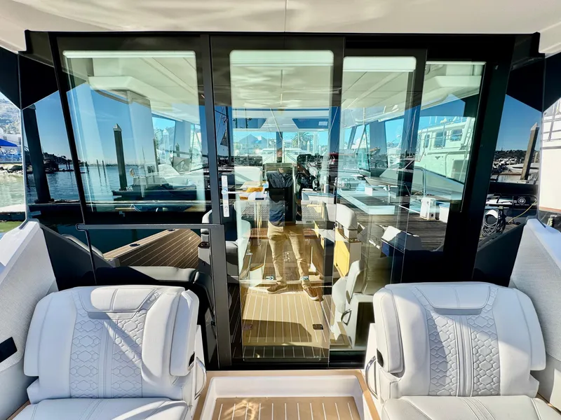 Slide: The Image of 2025 Tiara Yachts 43 LE interior view with luxurious seating and glass doors. - 17
