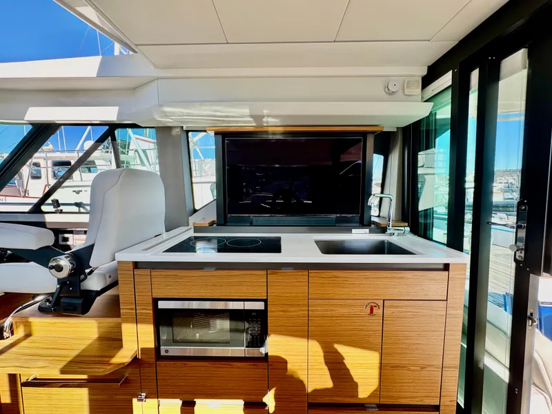 Slide: The Image of Interior of 2025 Tiara Yachts 43 LE, featuring a modern kitchen area. - 20