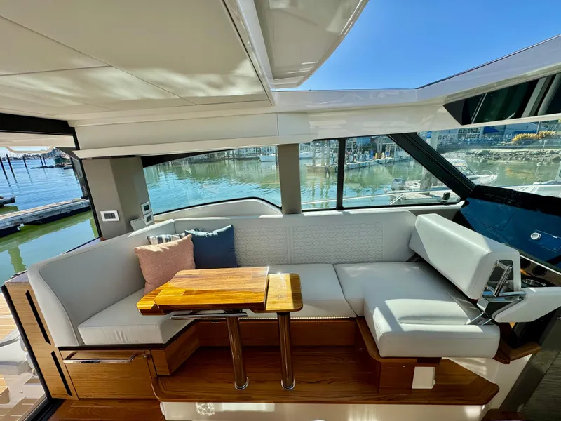 Slide: The Image of 2025 Tiara Yachts 43 LE interior with elegant seating and wooden table. - 24