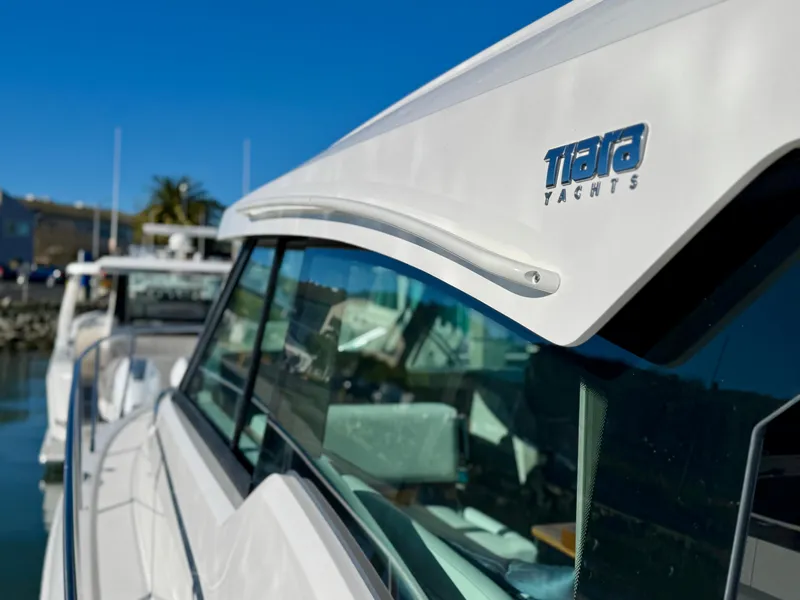 Slide: The Image of 2025 Tiara Yachts 43 LE, sleek design, docked under clear blue sky. - 34