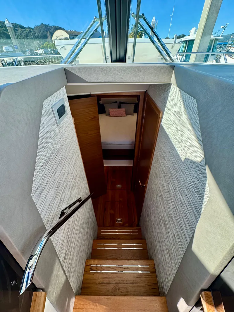 Slide: The Image of Interior view of 2025 Tiara Yachts 43 LE, featuring wooden stairs and modern design. - 40