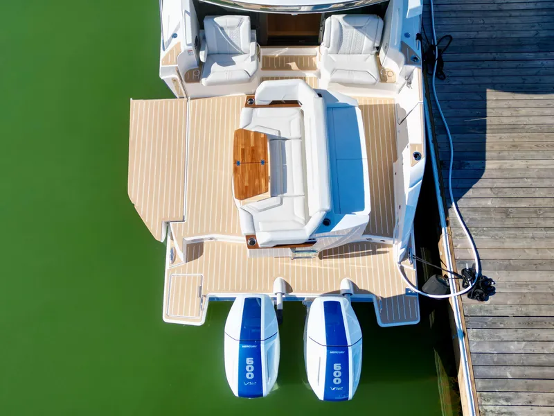 Slide: The Image of 2025 Tiara Yachts 43 LE with twin 600 engines docked on green water. - 5