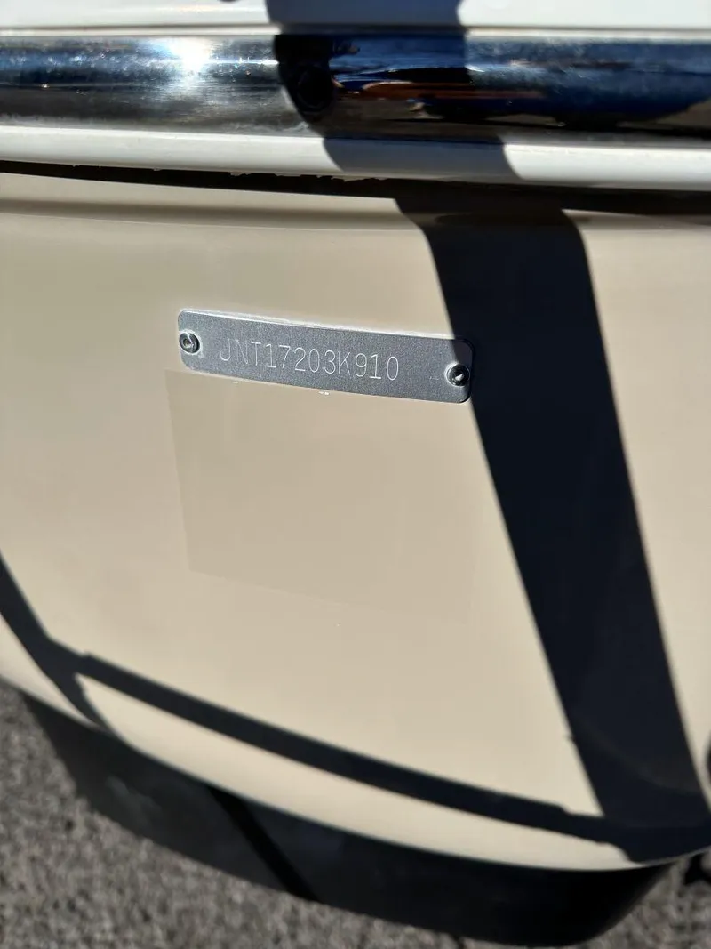 Slide: The Image of 2010 NauticStar 230DC Sport Deck boat with visible identification plate. - 4