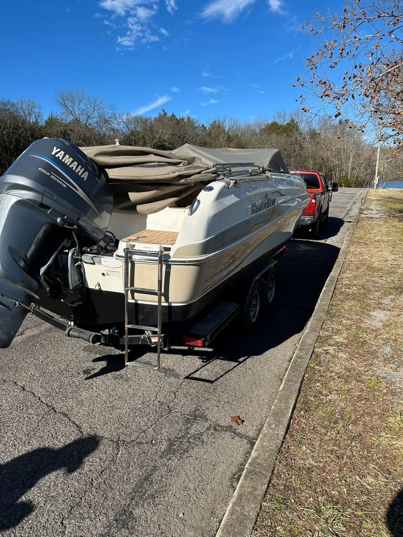 Slide: The Image of 2010 NauticStar 230DC Sport Deck boat on trailer, parked roadside, with Yamaha outboard motor. - 5