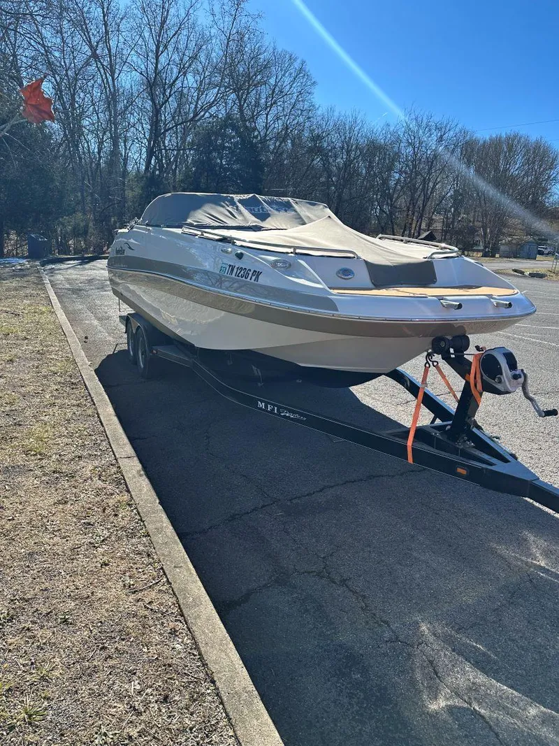 Slide: The Image of 2010 NauticStar 230DC Sport Deck boat on trailer, parked outdoors. - 6