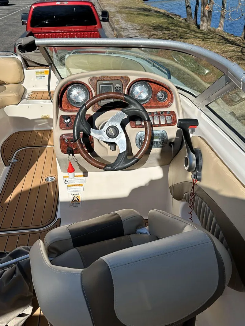 Slide: The Image of 2010 NauticStar 230DC Sport Deck boat interior with steering wheel and dashboard controls. - 9