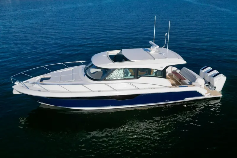 The Image of 2025 Tiara Yachts 48 LE cruising on calm blue waters. - 0
