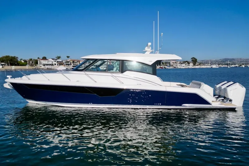 Slide: The Image of 2025 Tiara Yachts 48 LE, sleek design, cruising on calm waters. - 1
