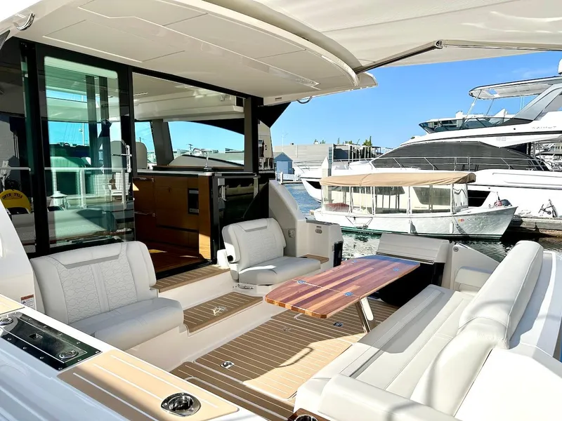 Slide: The Image of 2025 Tiara Yachts 48 LE luxury yacht interior with elegant seating and wooden table. - 12