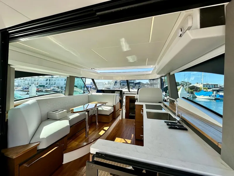 Slide: The Image of Luxurious interior of 2025 Tiara Yachts 48 LE, featuring modern seating and kitchen area. - 17