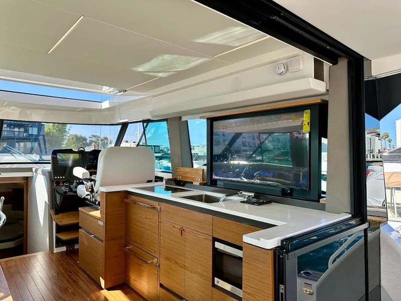 Slide: The Image of 2025 Tiara Yachts 48 LE interior with modern kitchen and helm station. - 18