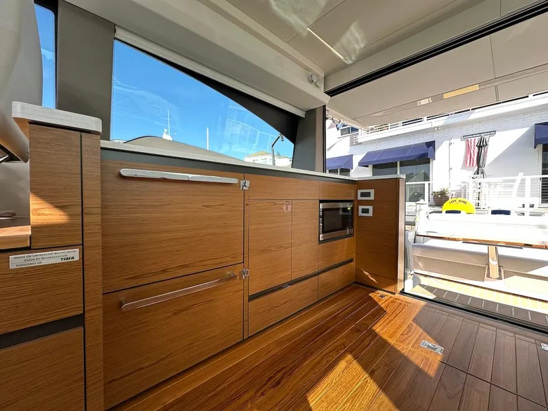 Slide: The Image of Interior of 2025 Tiara Yachts 48 LE, featuring sleek wooden cabinetry and modern design. - 19