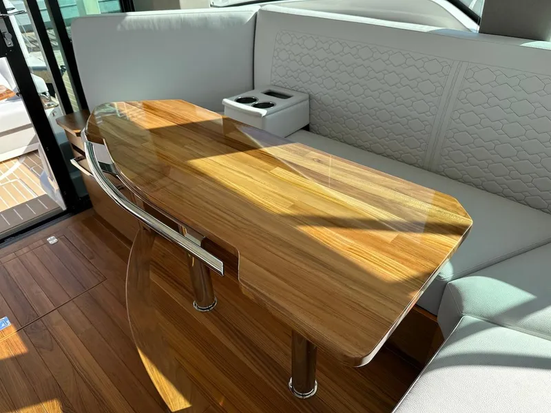 Slide: The Image of Luxurious interior of 2025 Tiara Yachts 48 LE with elegant wooden table and seating. - 21