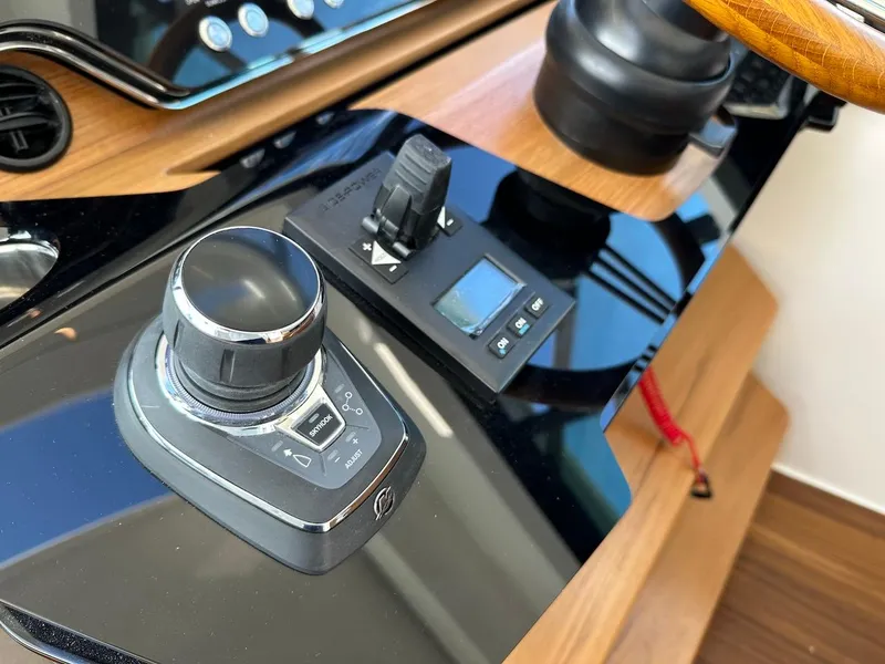 Slide: The Image of Control panel of 2025 Tiara Yachts 48 LE, featuring modern navigation equipment. - 24