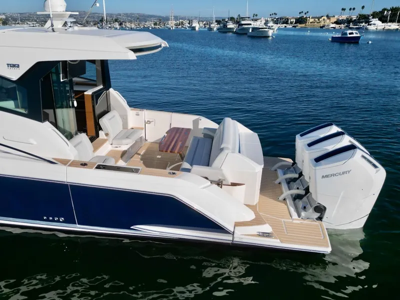 Slide: The Image of 2025 Tiara Yachts 48 LE with Mercury engines on calm water. - 3