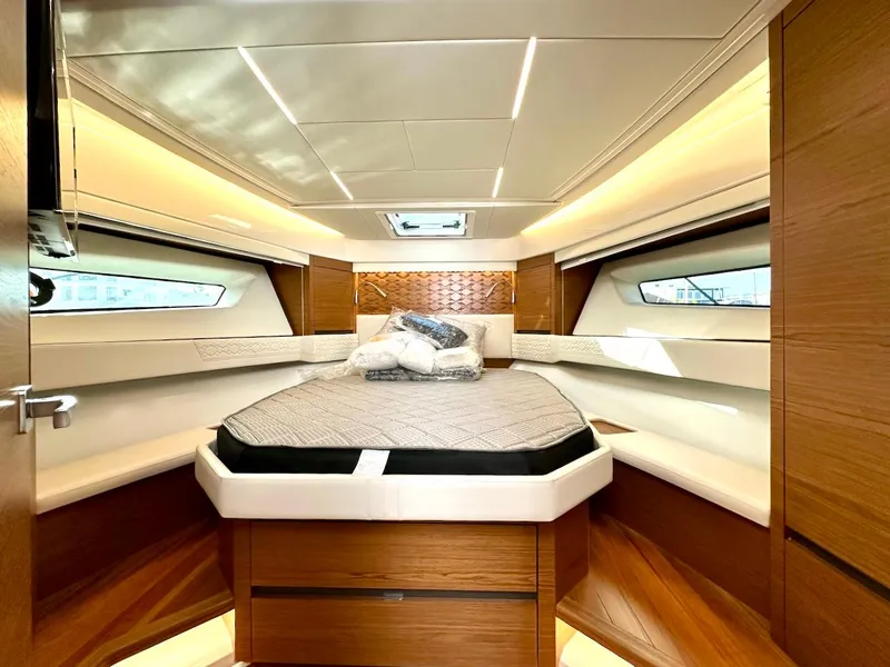 Slide: The Image of Luxurious cabin interior of 2025 Tiara Yachts 48 LE with modern design and cozy bedding. - 30