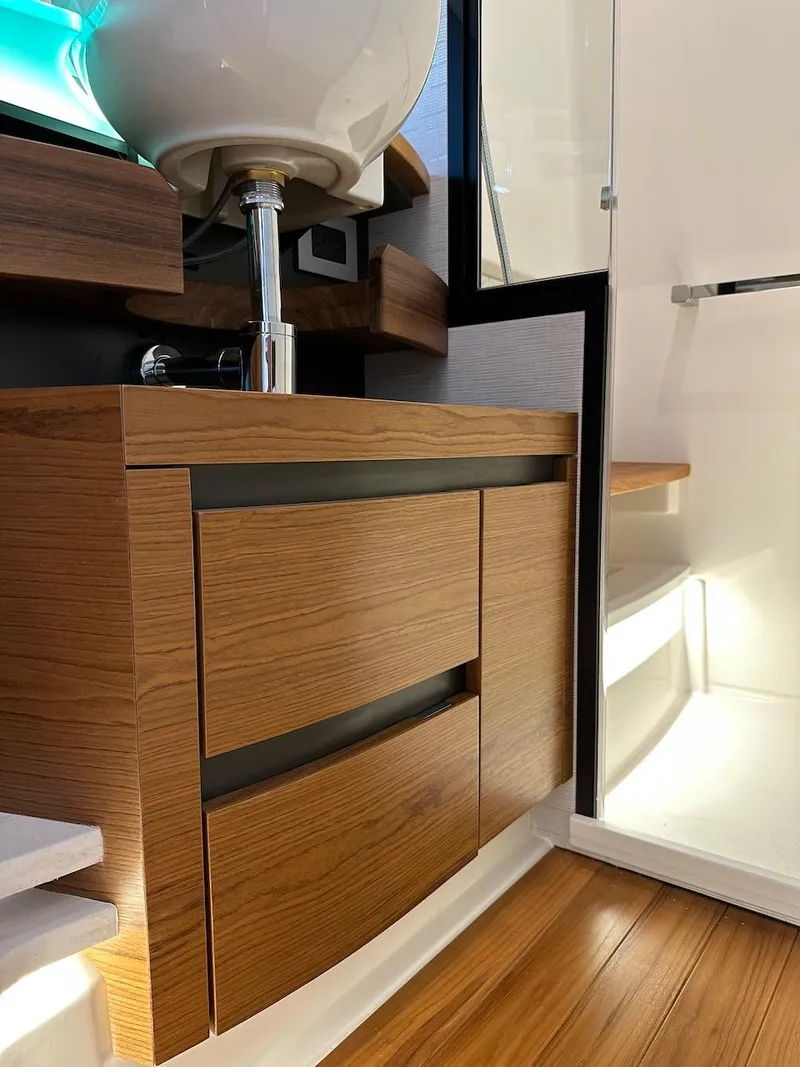 Slide: The Image of 2025 Tiara Yachts 48 LE interior with modern wood cabinetry and sleek design. - 38
