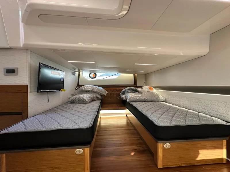 Slide: The Image of 2025 Tiara Yachts 48 LE interior with twin beds and modern design. - 41