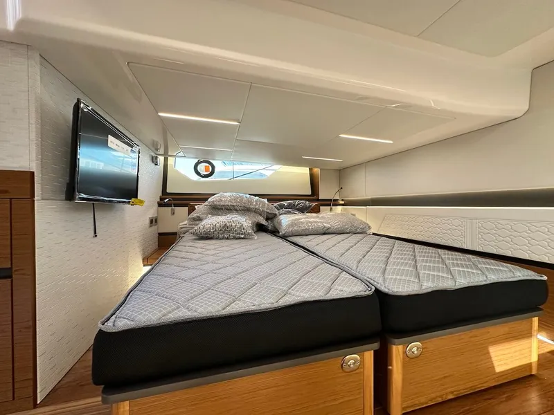 Slide: The Image of Interior cabin of 2025 Tiara Yachts 48 LE with twin beds and modern decor. - 42