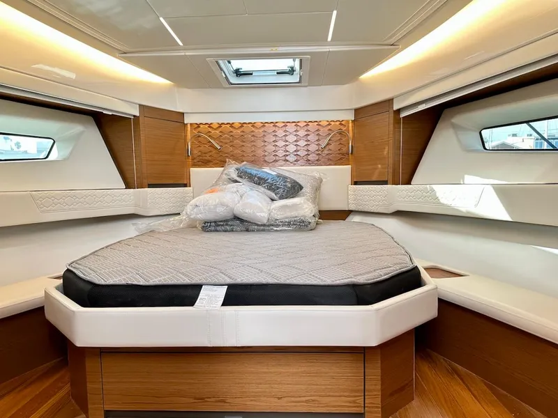 Slide: The Image of Luxurious cabin interior of 2025 Tiara Yachts 48 LE with modern design and comfortable bedding. - 49