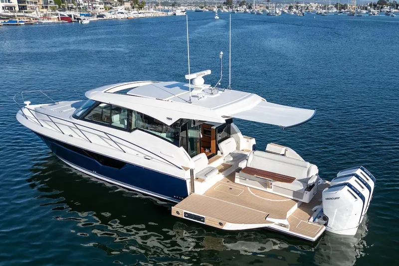 Slide: The Image of 2025 Tiara Yachts 48 LE luxury boat on calm water, showcasing sleek design and powerful engines. - 9