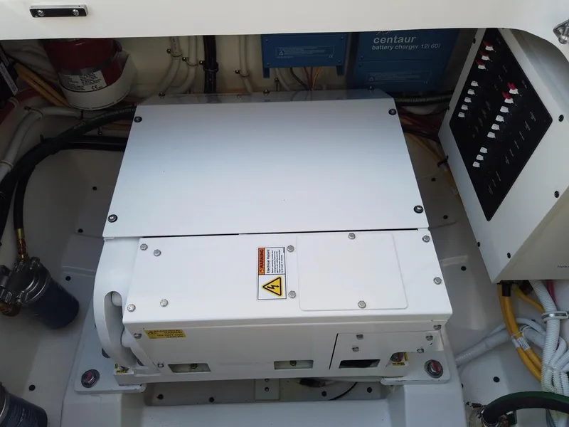 Slide: The Image of 2024 Tiara Sport 34LS engine compartment with electrical components and wiring. - 33
