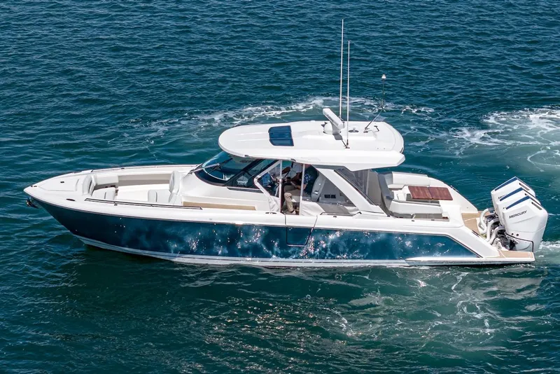 Slide: The Image of 2024 Tiara Yachts 38 LS cruising on open water, showcasing sleek design and powerful engines. - 11