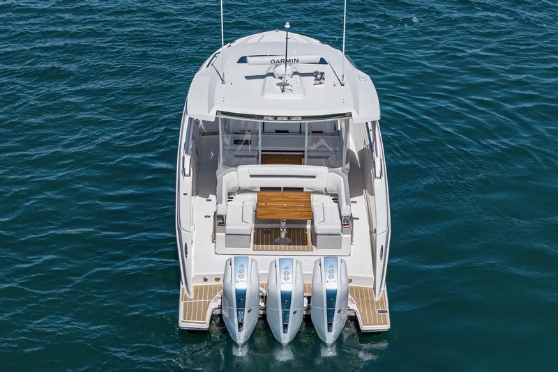 Slide: The Image of 2024 Tiara Yachts 38 LS with triple outboard engines on blue water. - 20