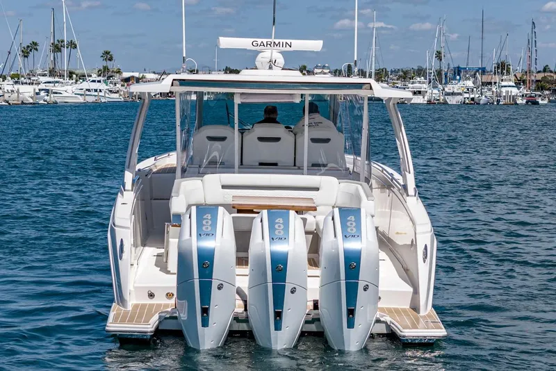 Slide: The Image of 2024 Tiara Yachts 38 LS with triple outboard engines on the water. - 21