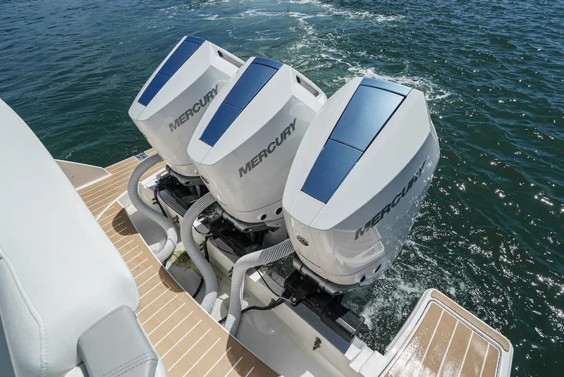 Slide: The Image of 2024 Tiara Yachts 38 LS with triple Mercury outboard engines on water. - 22