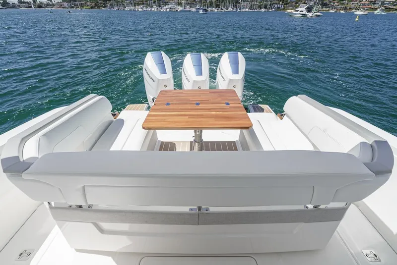 Slide: The Image of 2024 Tiara Yachts 38 LS with triple engines and elegant seating on open water. - 25