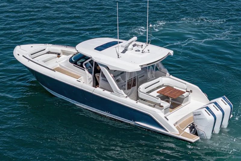 Slide: The Image of 2024 Tiara Yachts 38 LS cruising on open water, showcasing sleek design and powerful engines. - 4