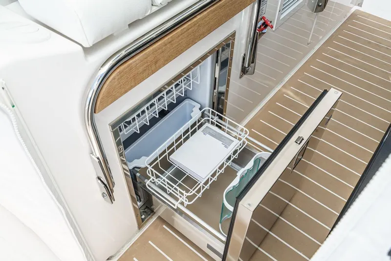 Slide: The Image of 2024 Tiara Yachts 38 LS interior with open refrigerator drawer. - 48