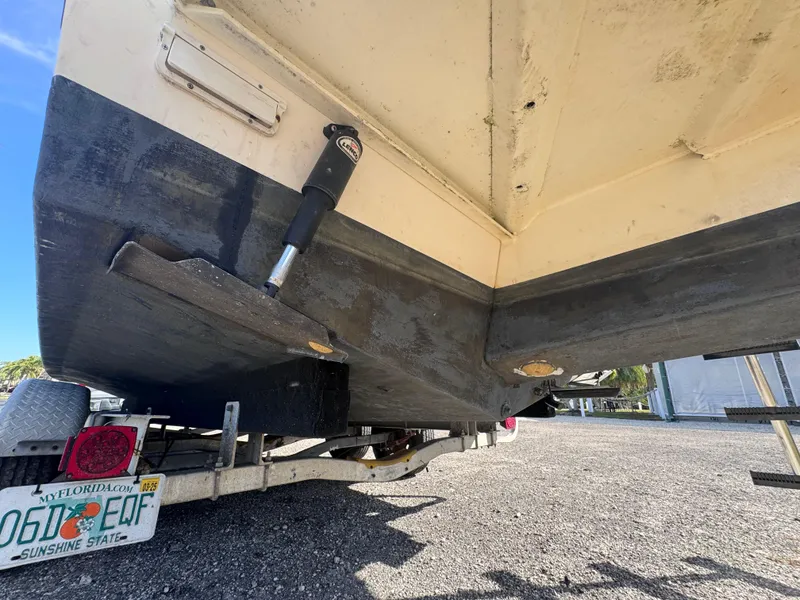 Slide: The Image of 2005 Parker 2520 Deep Vee Sport Cabin boat on trailer, showing hull and trim tabs. - 10