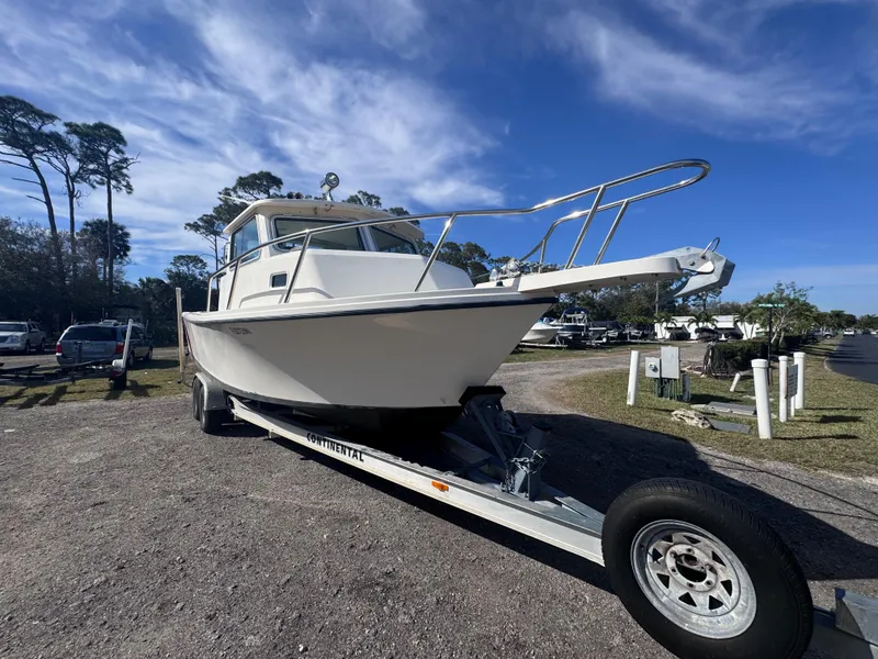 Slide: The Image of 2005 Parker 2520 Deep Vee Sport Cabin boat on trailer under blue sky. - 2