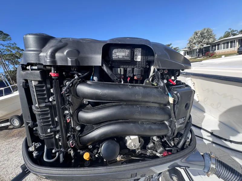 Slide: The Image of Close-up of a 2005 Parker 2520 Deep Vee Sport Cabin boat engine under a clear blue sky. - 20