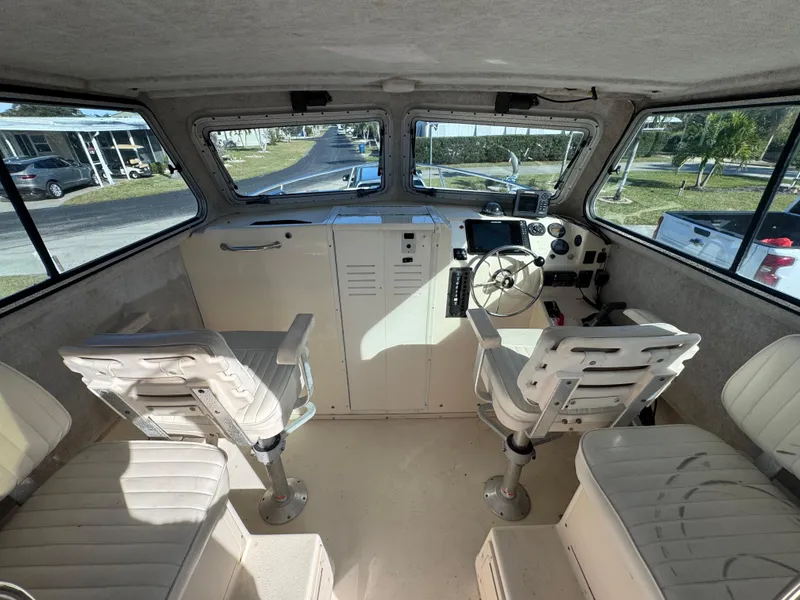Slide: The Image of Interior of 2005 Parker 2520 Deep Vee Sport Cabin with helm and seating. - 22