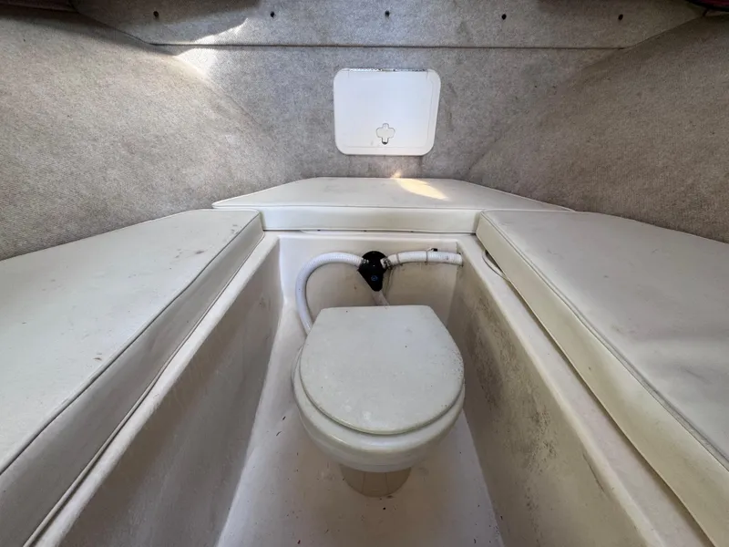 Slide: The Image of 2005 Parker 2520 Deep Vee Sport Cabin interior with marine toilet. - 27