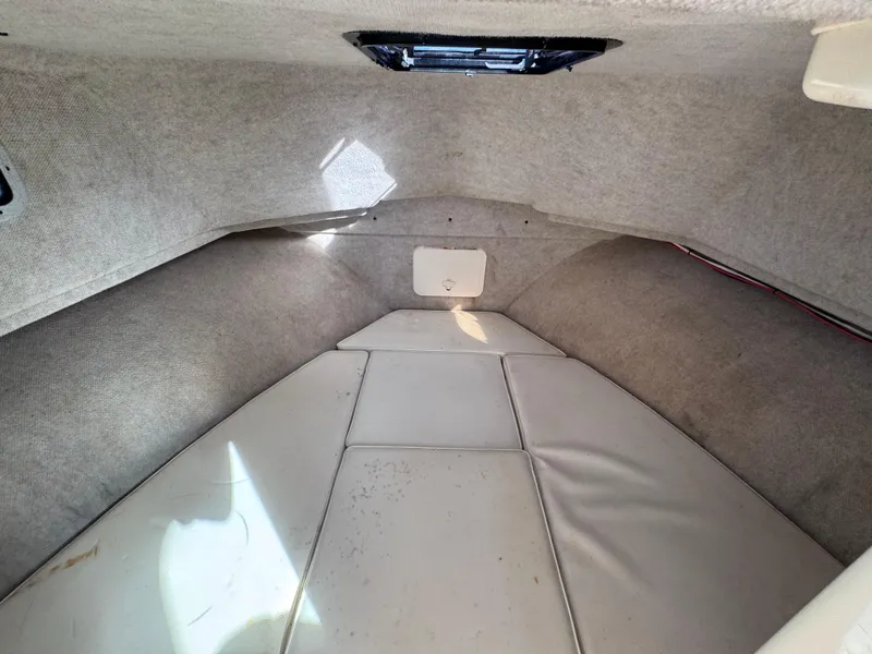 Slide: The Image of 2005 Parker 2520 Deep Vee Sport Cabin interior with cushioned seating. - 28