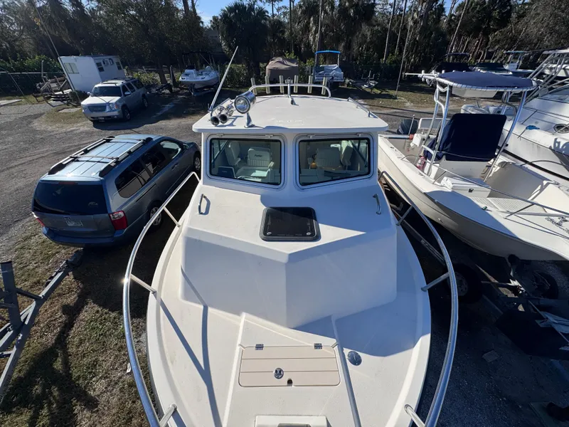 Slide: The Image of 2005 Parker 2520 Deep Vee Sport Cabin boat in a marina, top view. - 29