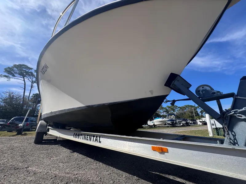 Slide: The Image of 2005 Parker 2520 Deep Vee Sport Cabin boat on trailer, parked outdoors under blue sky. - 3