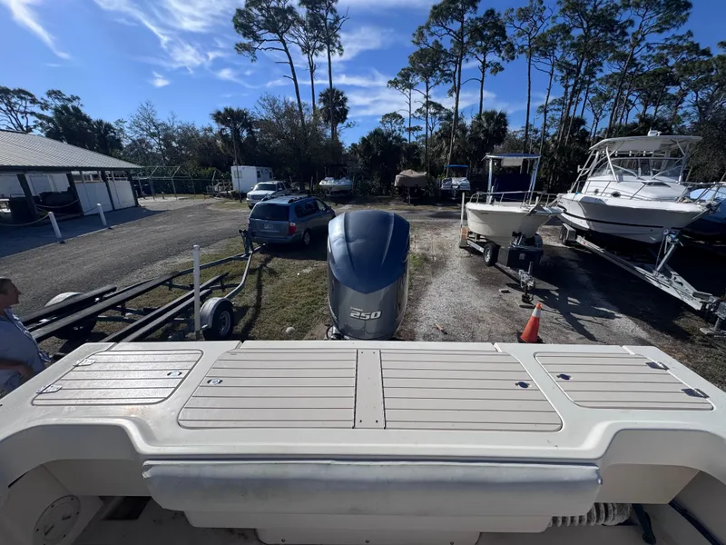 Slide: The Image of 2005 Parker 2520 Deep Vee Sport Cabin boat with outboard motor, parked outdoors. - 34