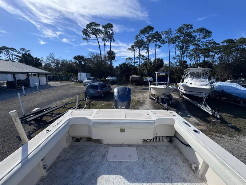 Slide: The Image of 2005 Parker 2520 Deep Vee Sport Cabin boat in a marina with trees and blue sky. - 35