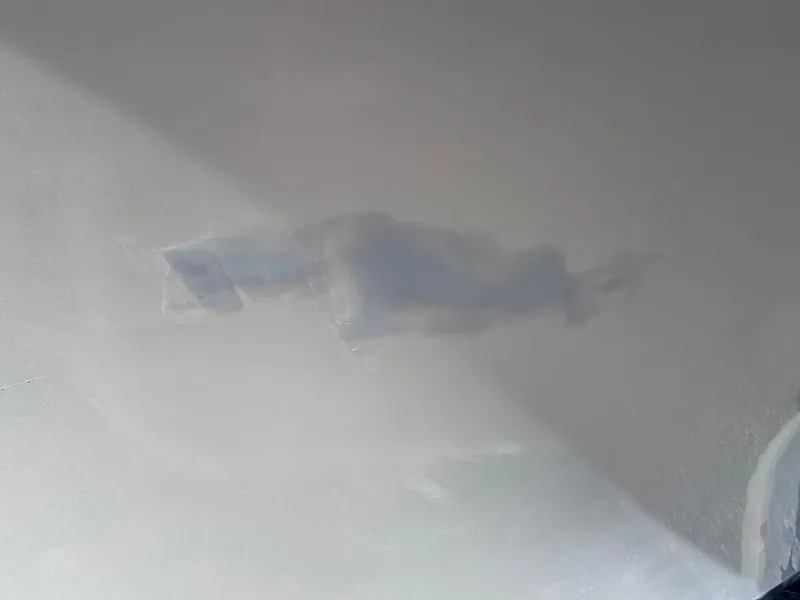 Slide: The Image of Close-up of a 2005 Parker 2520 Deep Vee Sport Cabin boat hull with visible damage. - 40