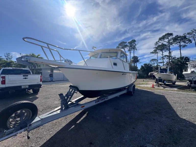 Slide: The Image of 2005 Parker 2520 Deep Vee Sport Cabin boat on trailer under sunny sky. - 6