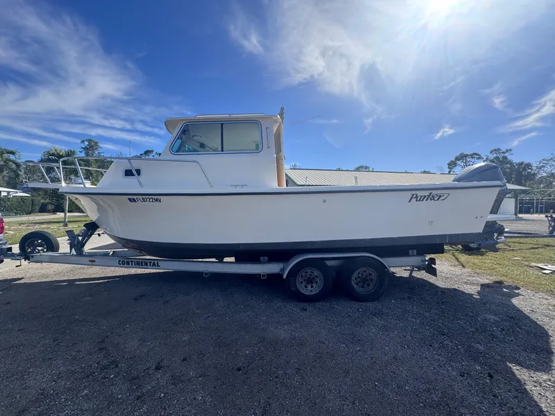 Slide: The Image of 2005 Parker 2520 Deep Vee Sport Cabin boat on trailer under clear sky. - 8